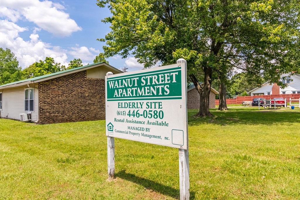 a sign in front of a house that says walnut street apartments