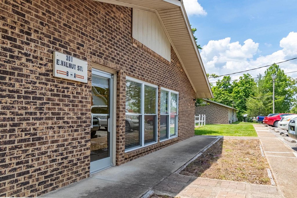 a brick building with a sidewalk in front of it