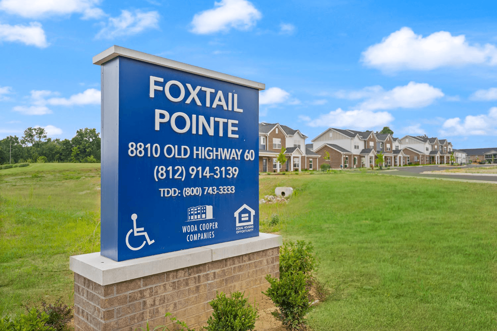 A sign for Foxtail Pointe with a wheelchair symbol indicating it is handicap accessible.