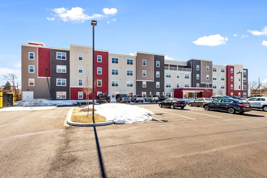 an empty parking lot in front of an apartment building