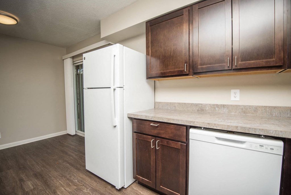 a kitchen with white appliances and wooden cabinets