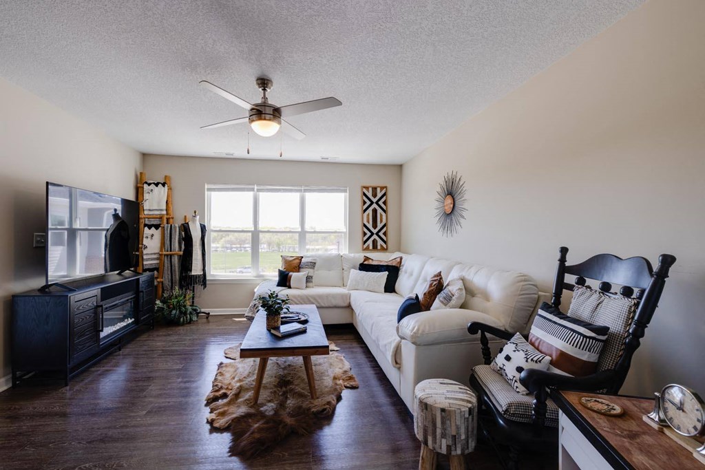 a living room with a white couch and a large window