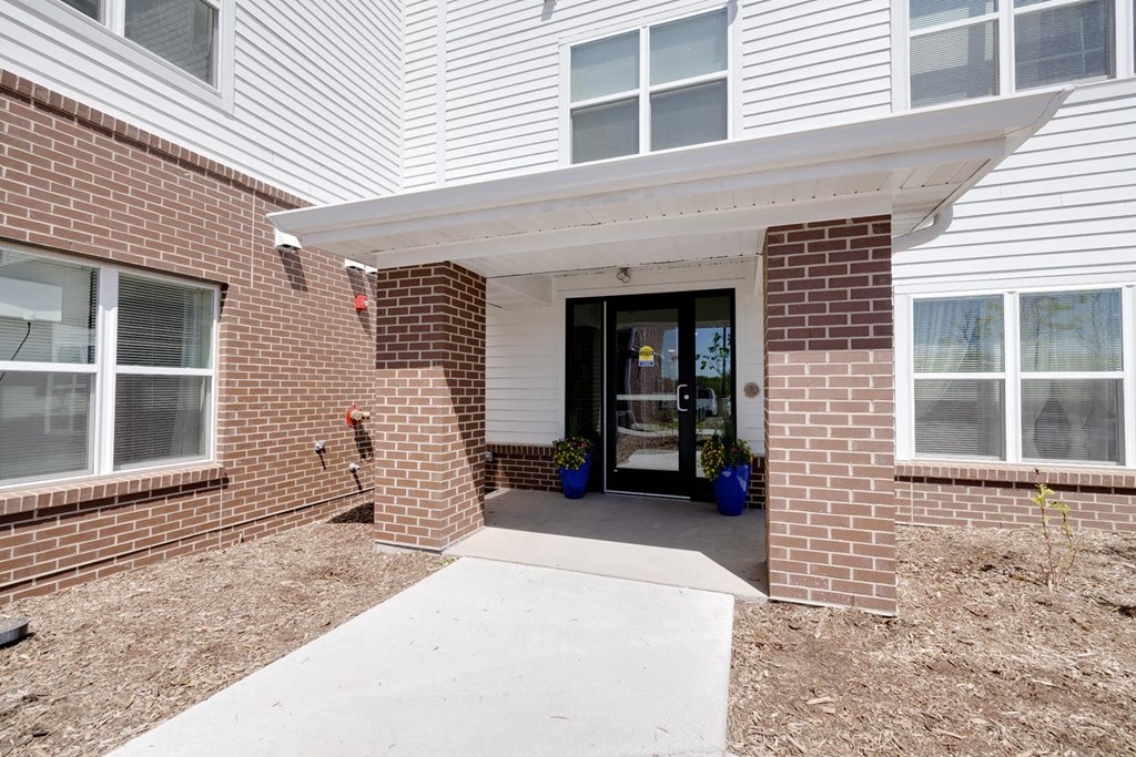 a brick building with a glass door