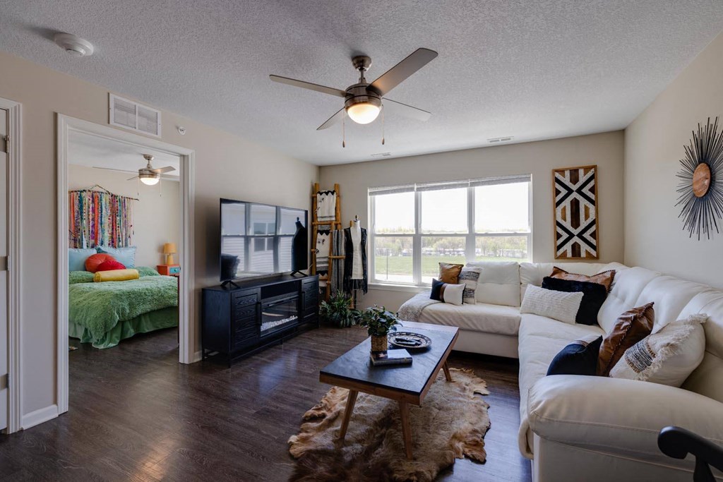 a living room with a couch and a ceiling fan
