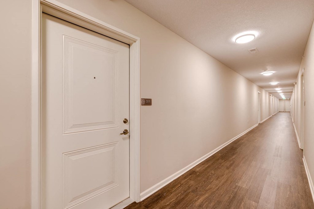 a bedroom with a medium sized bed and a doorway leading to a hallway