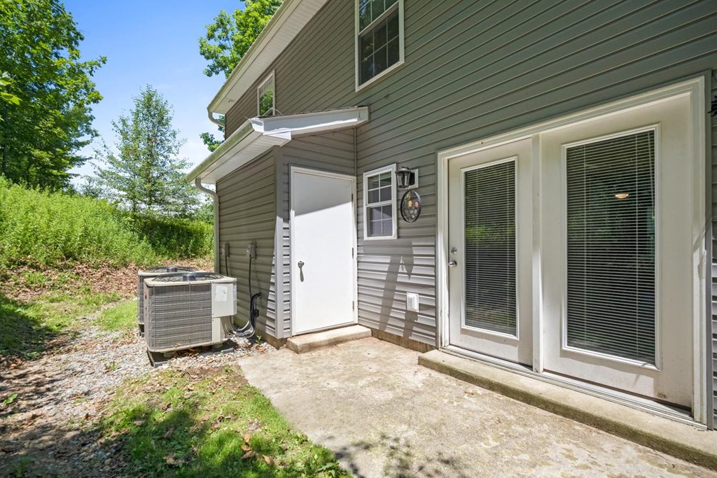 a side view of a house with a patio and a door