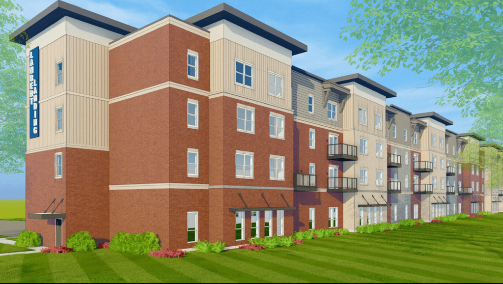 a rendering of a three story apartment building with a green lawn