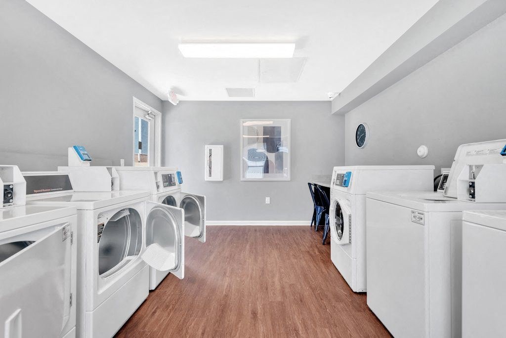 a laundry room filled with washes and dryers