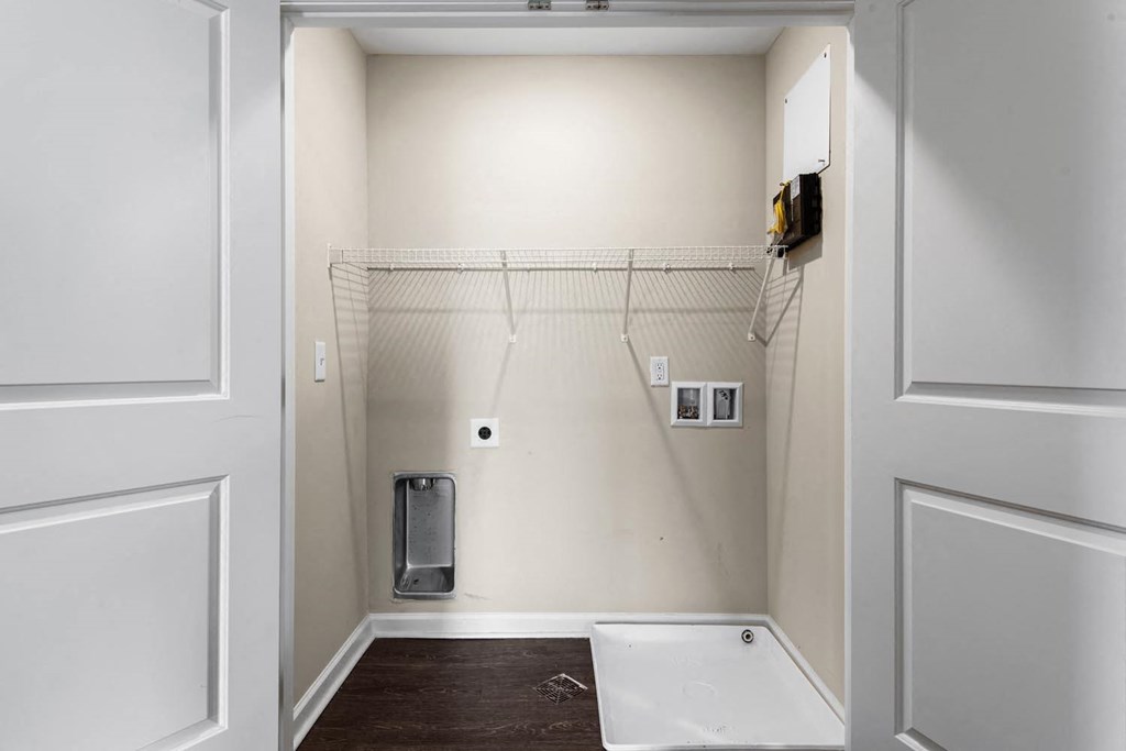 a small laundry room with a shower and a washer and dryer