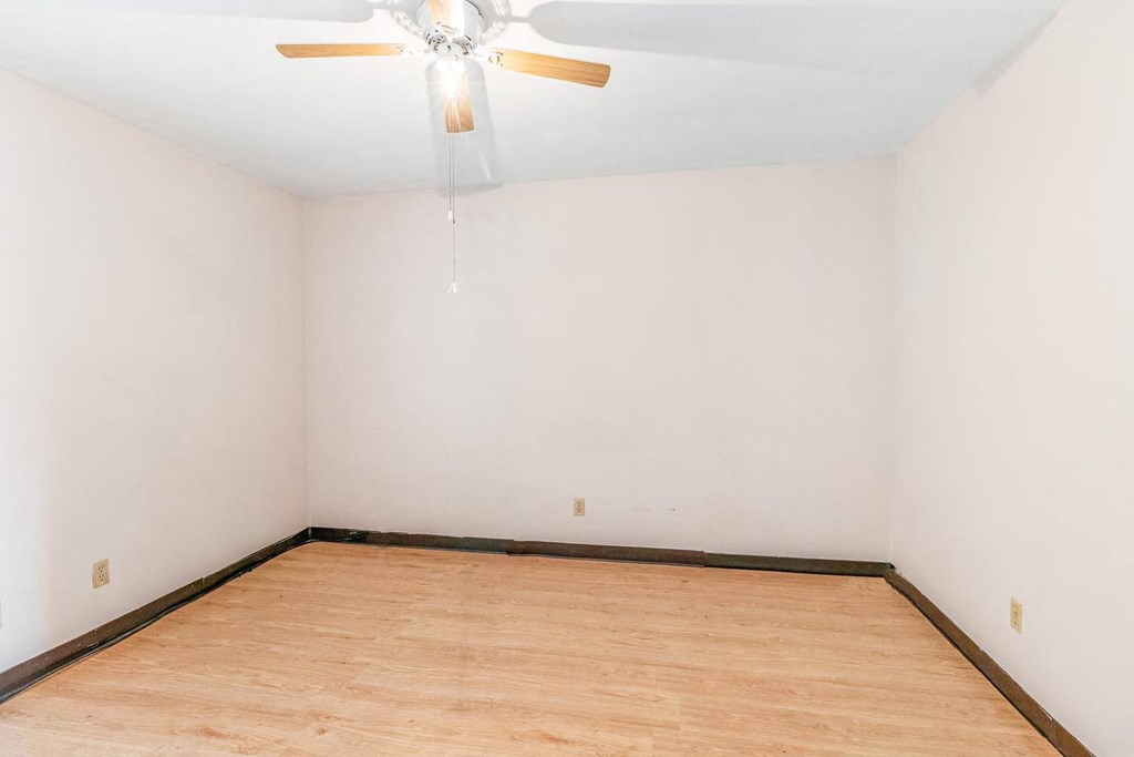 a room with white walls and a wooden floor