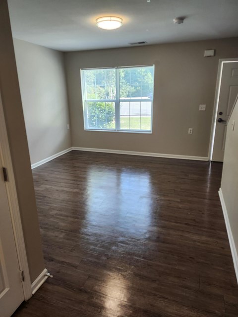 A room with wooden floors and a window.
