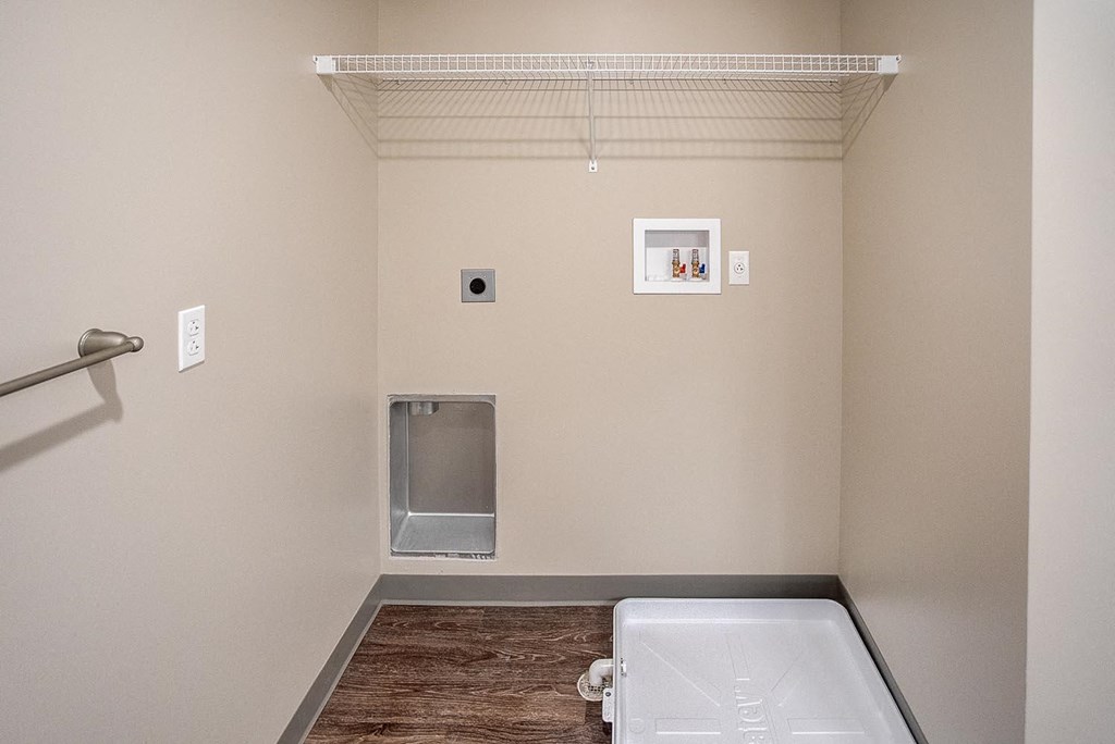 a bathroom with a white tub and a shower and a toilet and a wallesa