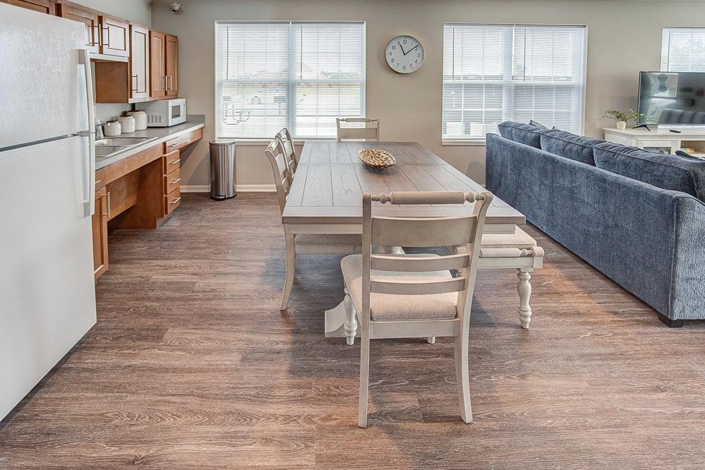 a living room with a dining room table and chairs
