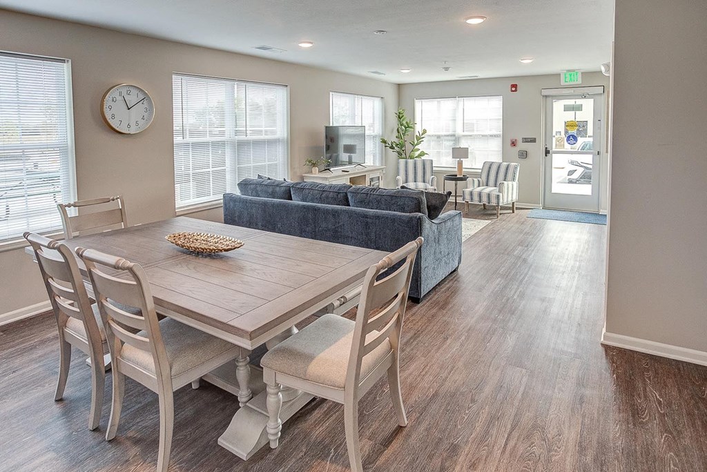 a dining room and living room with a table and chairs