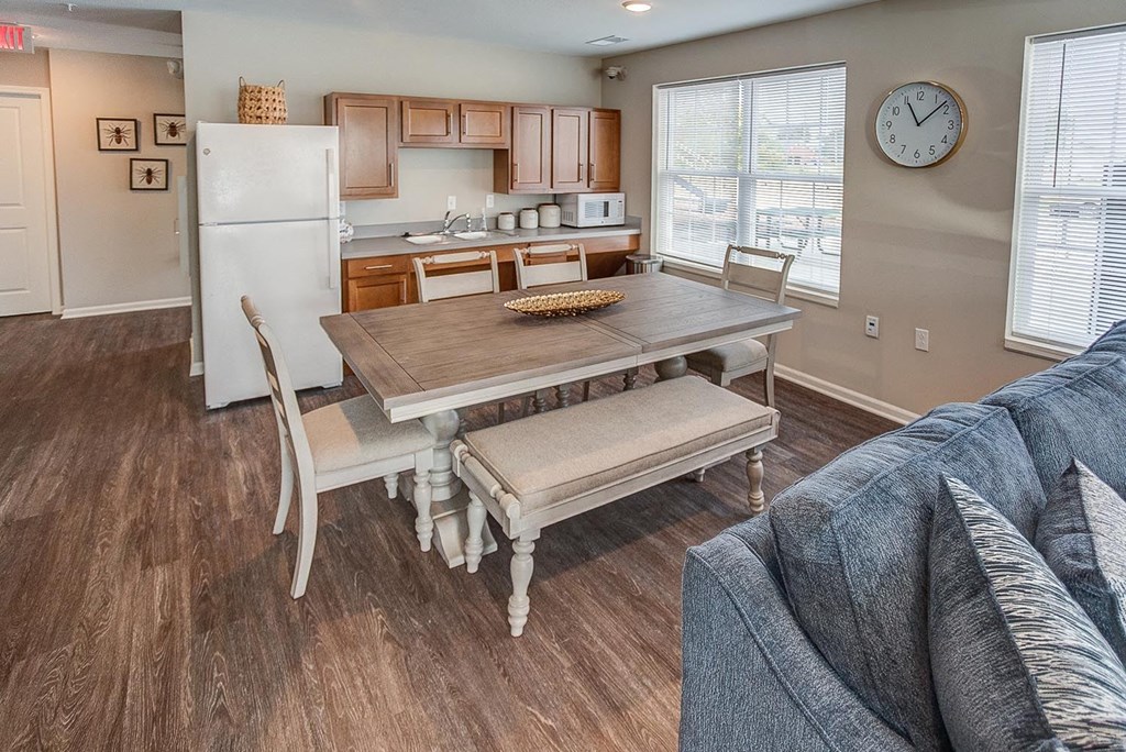 a living room with a dining room table and a kitchen