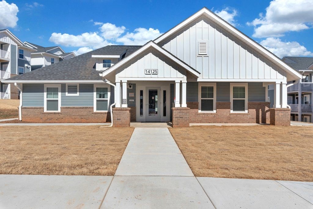 a white house with a sidewalk in front of it