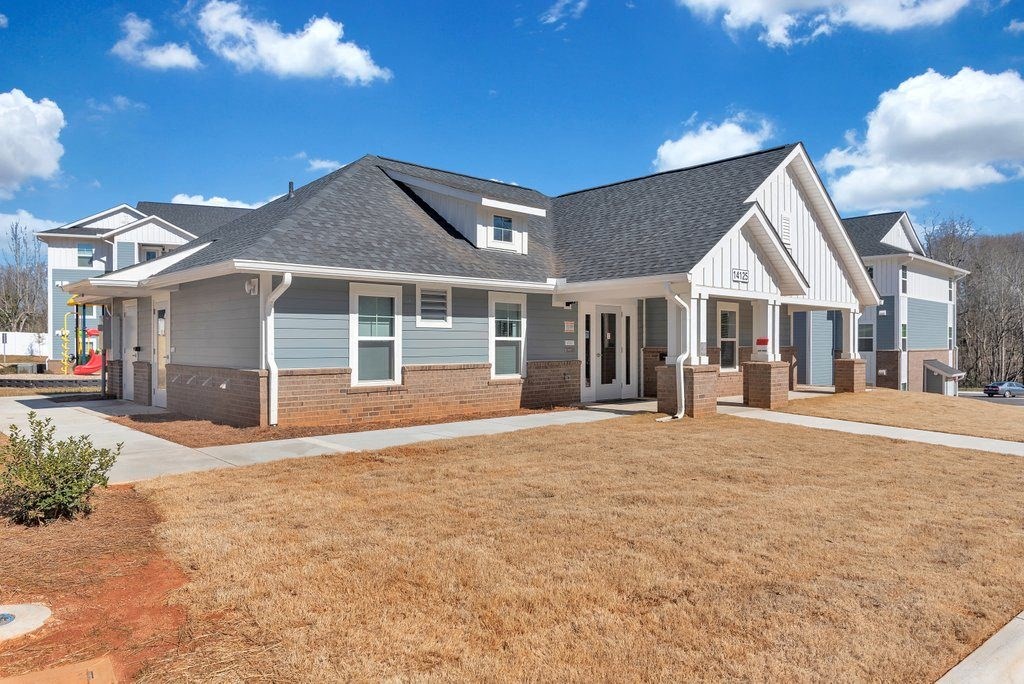 a large house with a yard in front of it