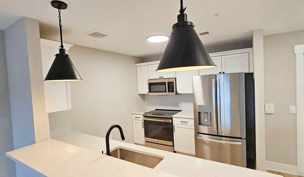 a kitchen with stainless steel appliances and black lights