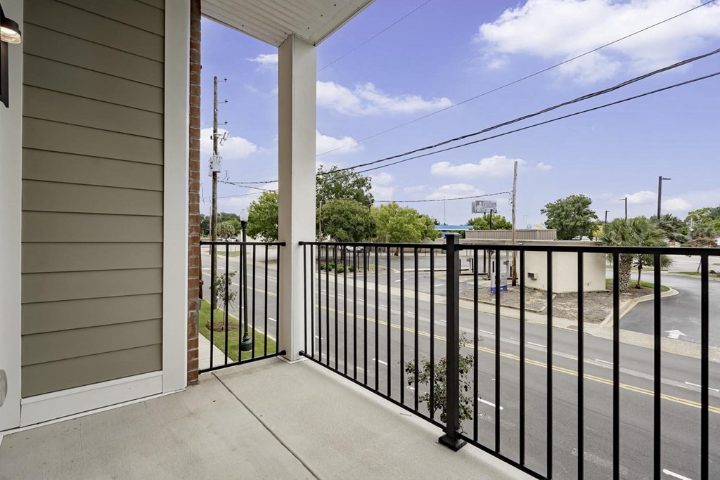 the view from the balcony of a home with a metal railing