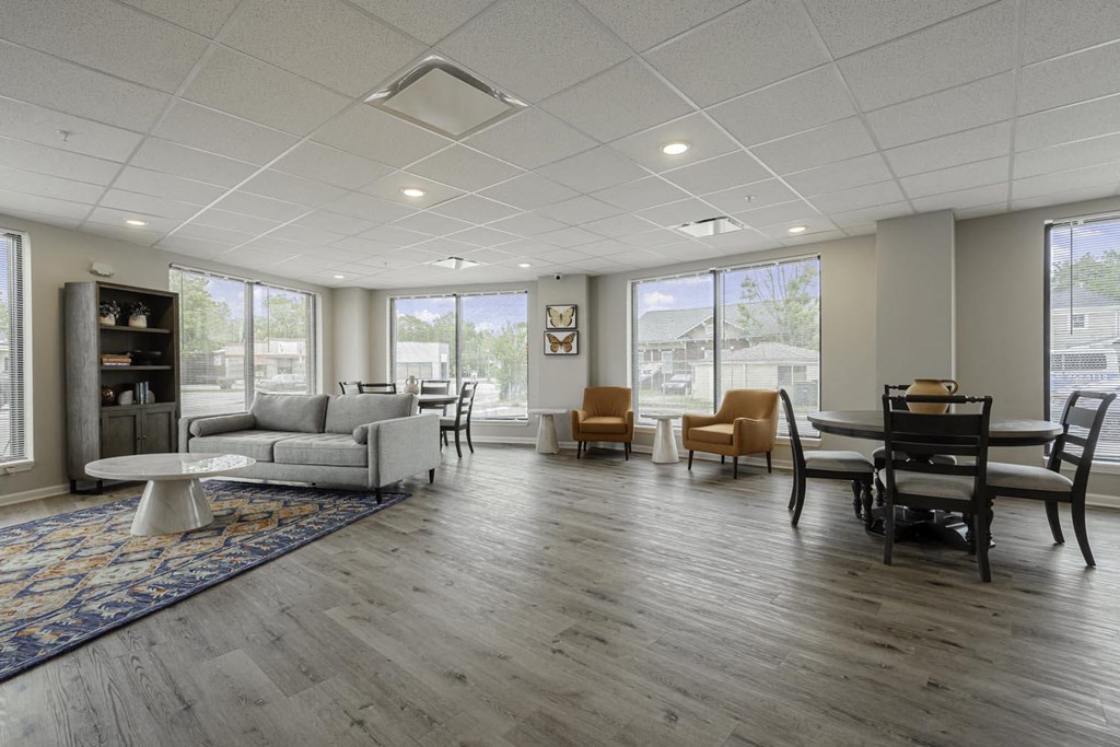 a living room with couches and chairs and a piano