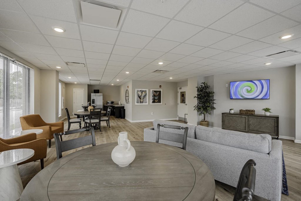 a living room with couches and chairs and a table