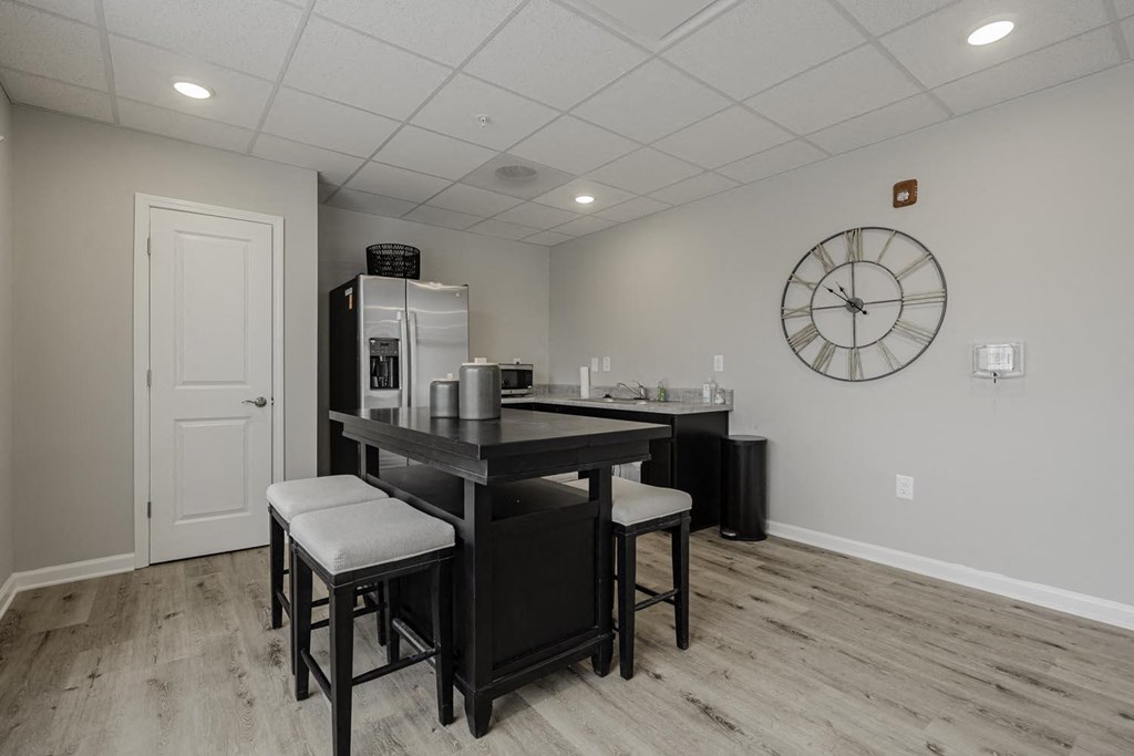 a kitchen with a large counter and a clock on the wall