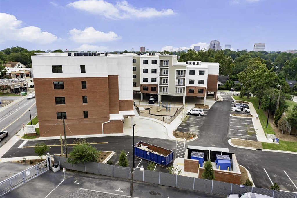 an aerial view of a building and a parking lot