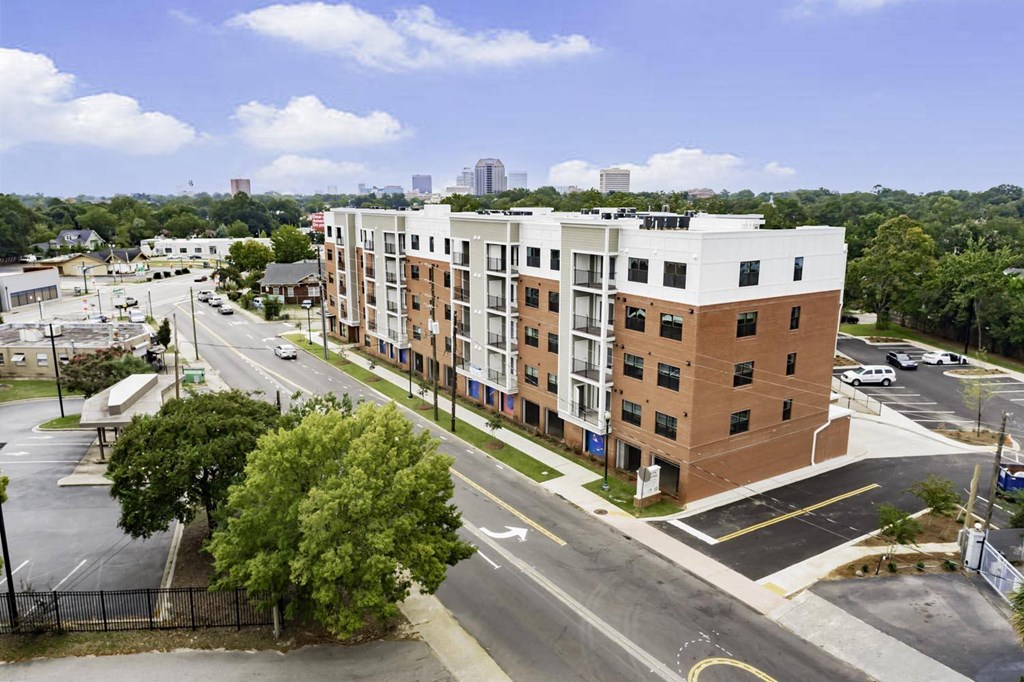 an aerial view of an apartment building on a city street