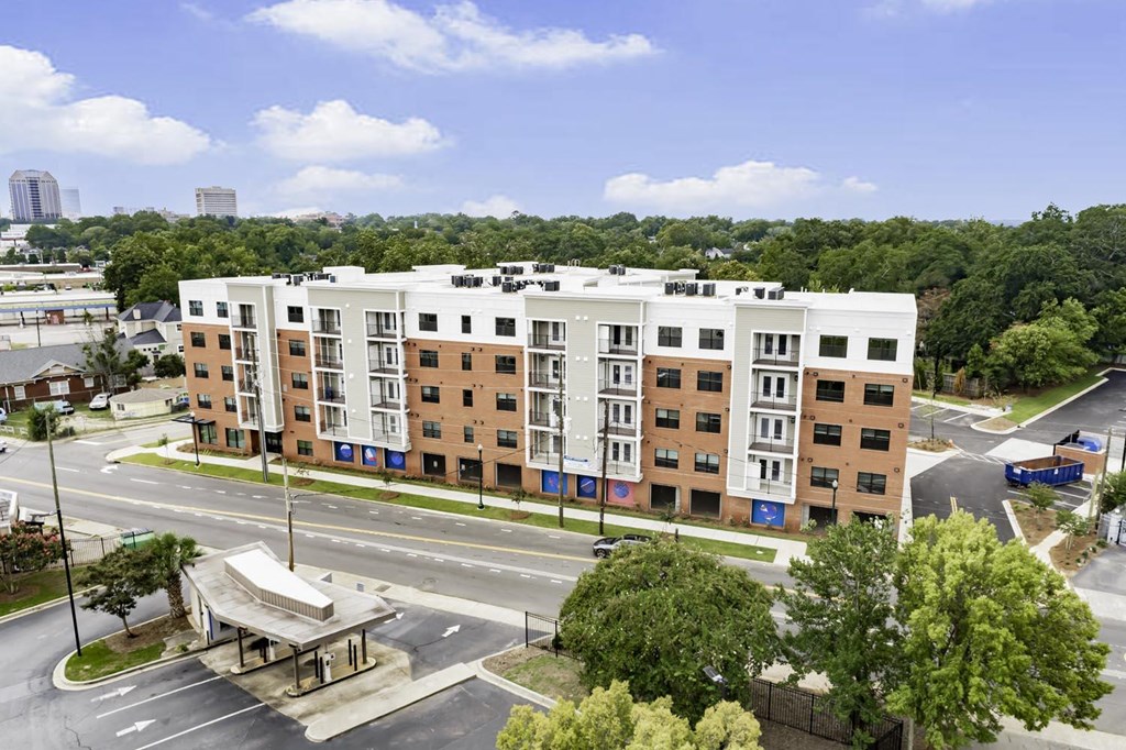 an aerial view of an apartment building in front of a street