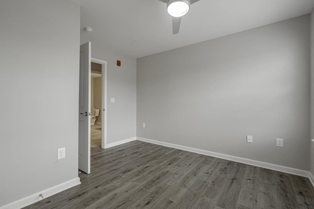a living room with white walls and wood floors