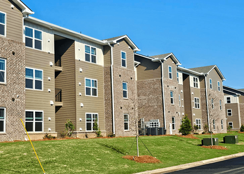 Apartment building with a yellow line in front of it.