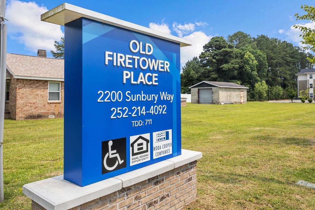 a sign for an old firetower place with a handicapped accessible sign on it