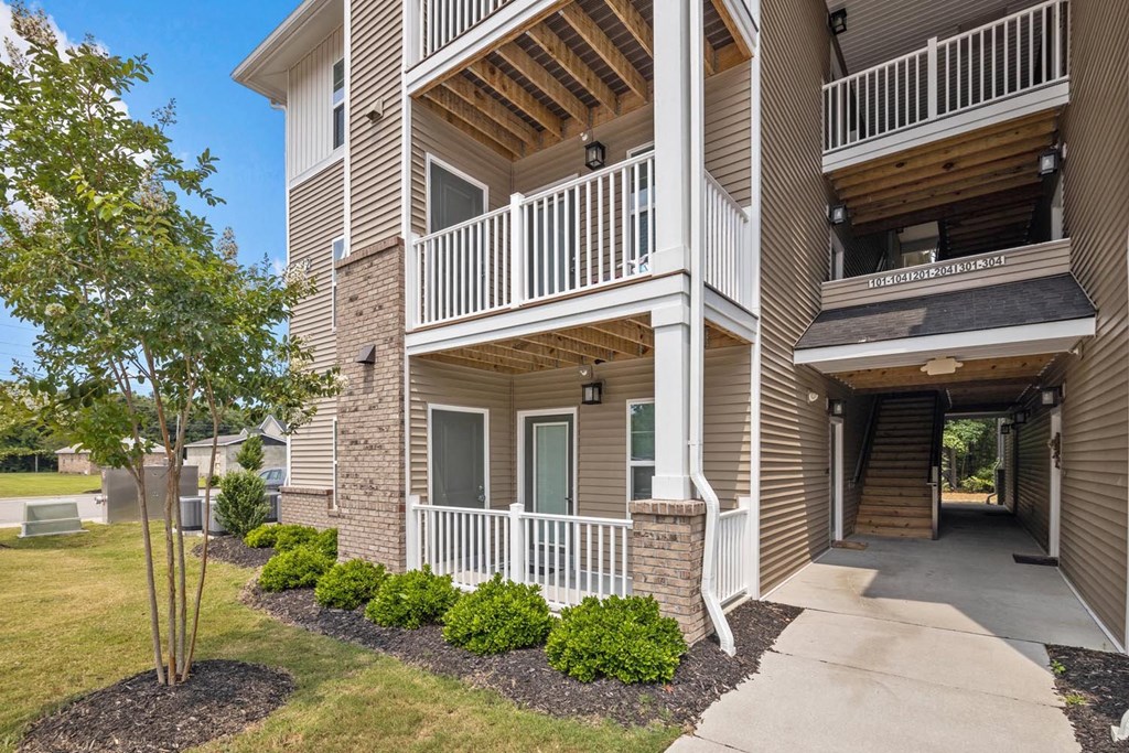 the walkway to the entrance of an apartment building