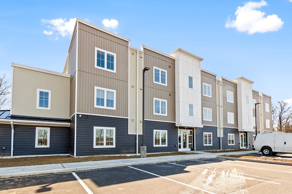 a row of apartment buildings with a street in front of them