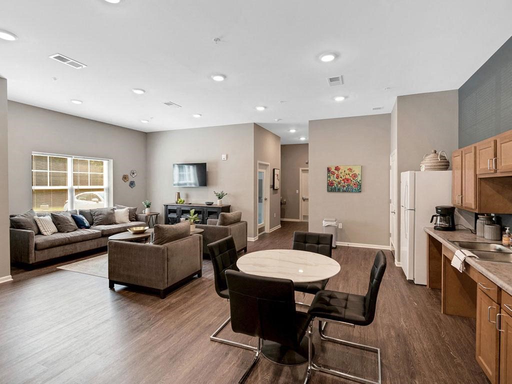 a living room with a kitchen and a table