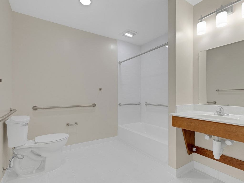 a bathroom with a toilet and a sink and a shower