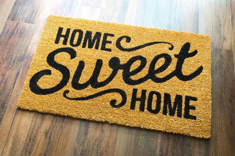 a welcome mat that reads home sweet home on a wooden floor