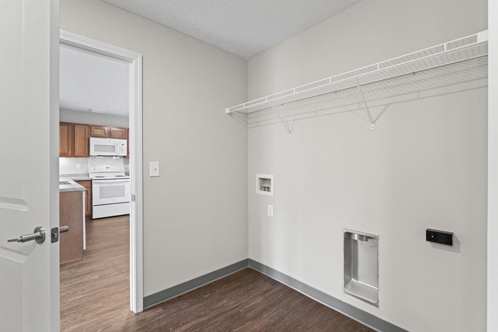 a bedroom with a door to a kitchen and a closet