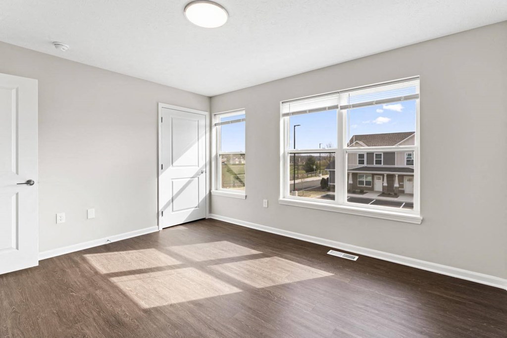 a living room with a large window and a door