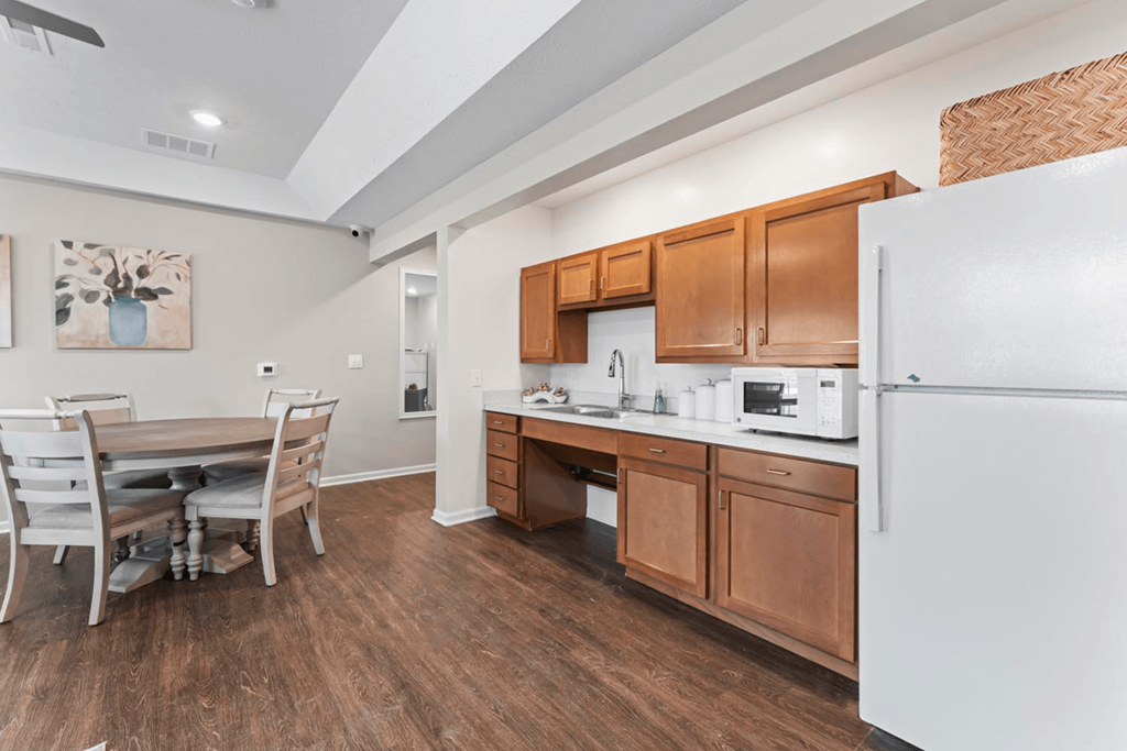 a kitchen with a dining table and a refrigerator