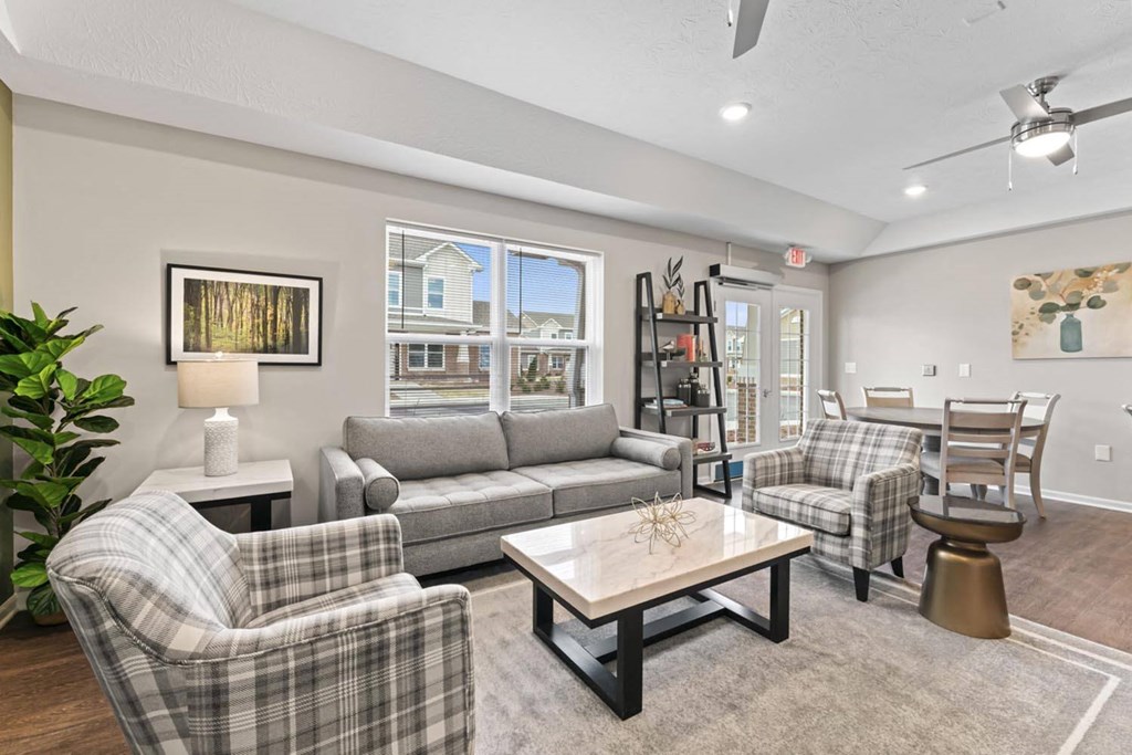 a living room with couches and chairs and a table