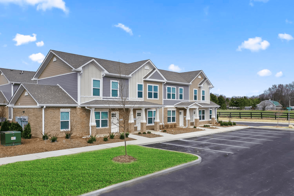a row of houses with a parking lot in front of them