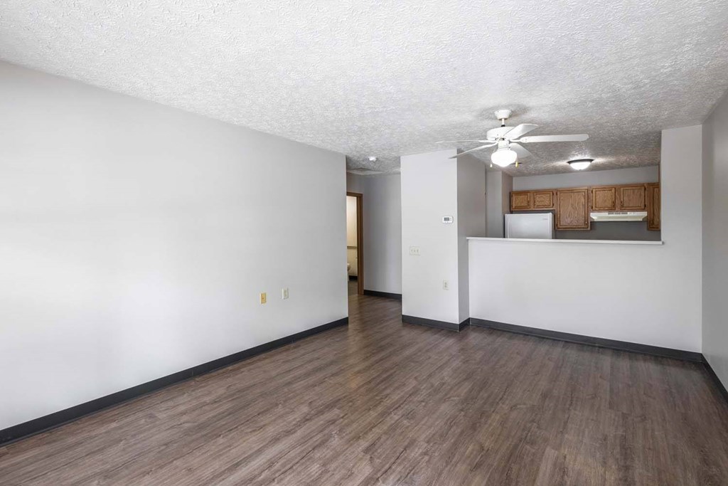 A room with wooden flooring and white walls.