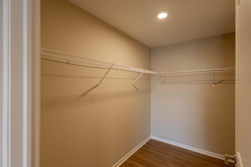 Empty room with white walls and wood flooring.