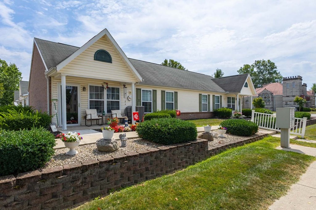 A house with a grey roof and a white fence.