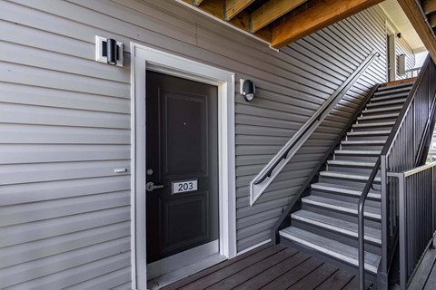 A black door with the number 203 on it.