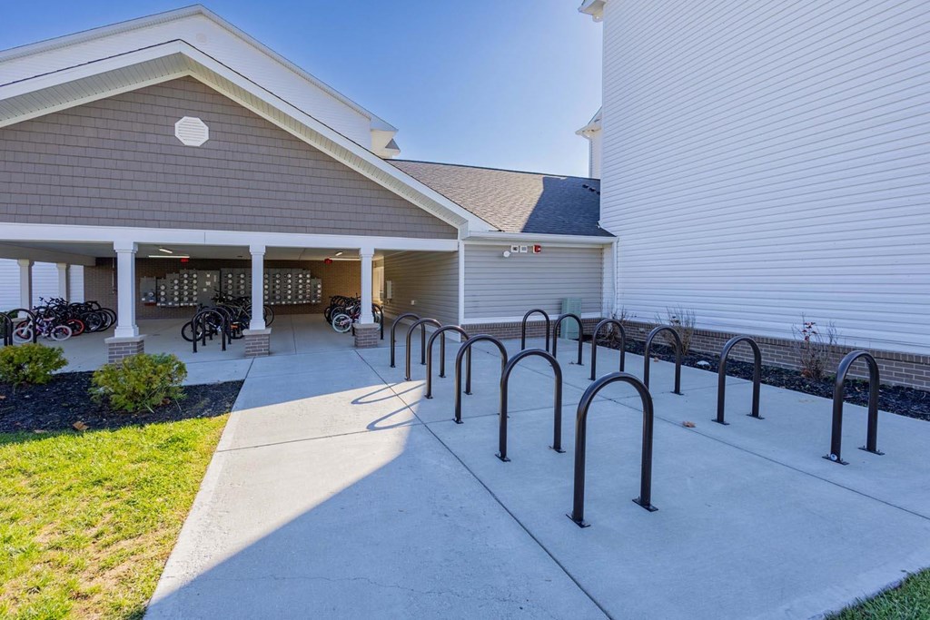 A building with a grey roof and a white wall with a circular window.