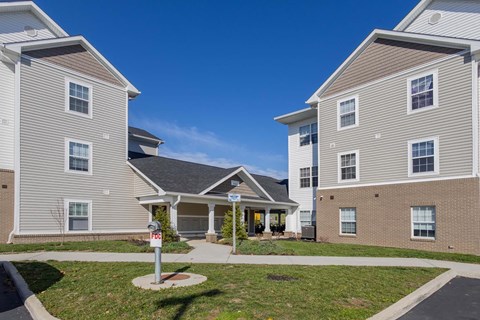 A residential area with two buildings and a mailbox in the foreground.