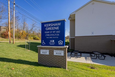 A sign for Kershaw Green stands in front of a building.