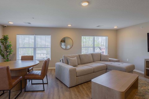 A living room with a couch, chairs, and a coffee table.